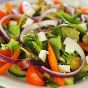 A vibrant Mediterranean salad featuring fresh vegetables, olives, and feta cheese for a healthy meal.